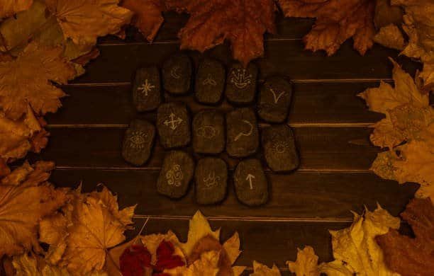 wicca divination runes over wooden planks